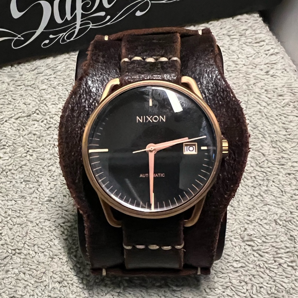 Nixon automatic mellor comes on a custom distressed leather cuff band